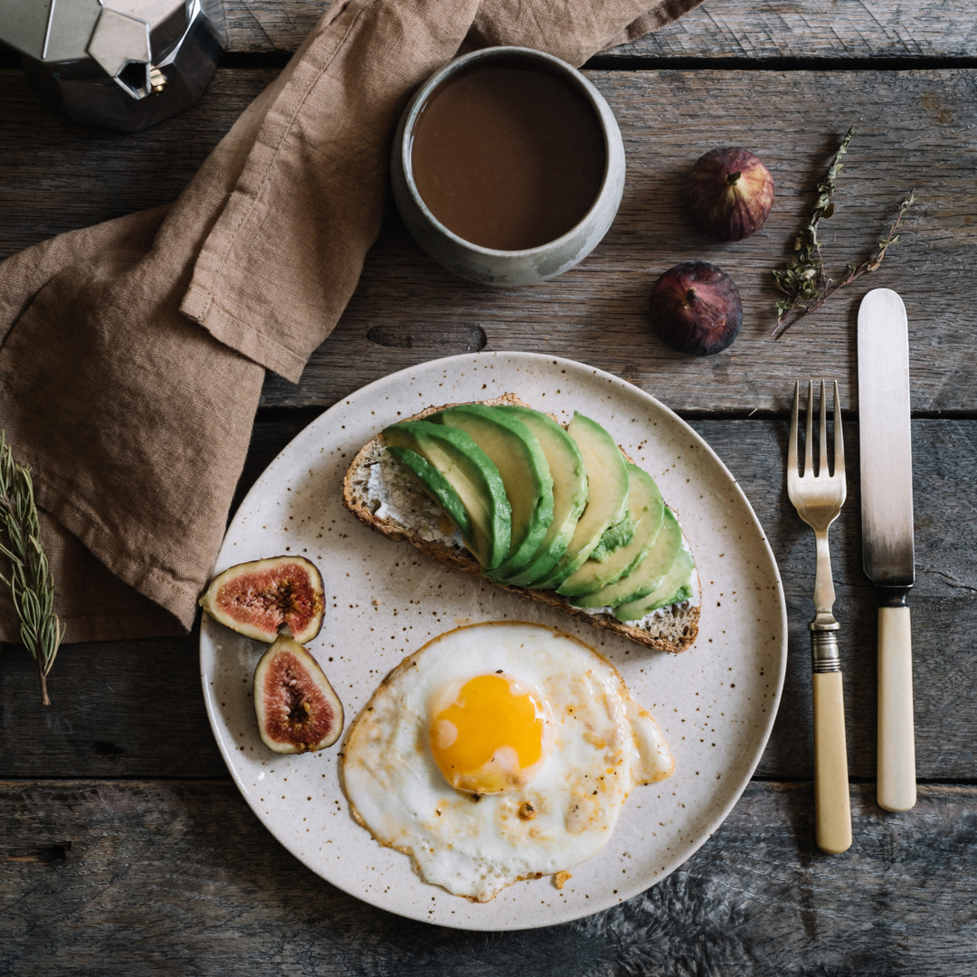 breakfast with avocado and eggs on toast and coffee