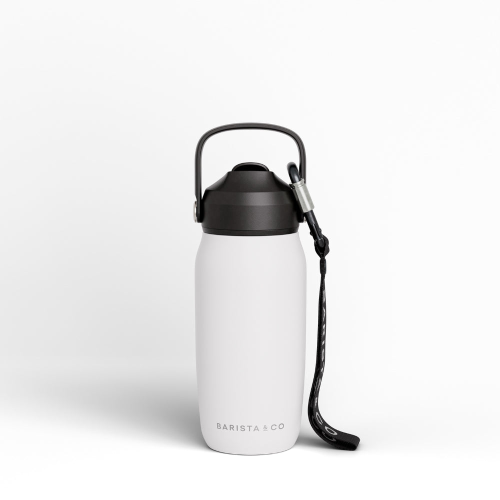 A matte white insulated water bottle with a black lid, carrying loop, and black wrist strap, shown on a clean white background. The brand name 'BARISTA & CO' is printed near the bottom.