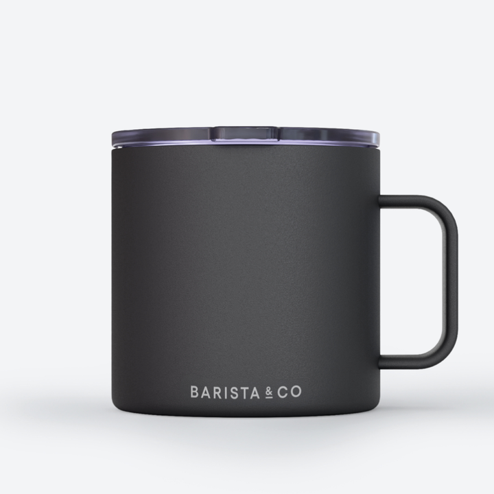 A matte black insulated mug with a matching black handle and lid, featuring the white text 'BARISTA & CO' near the bottom, set against a clean white background.