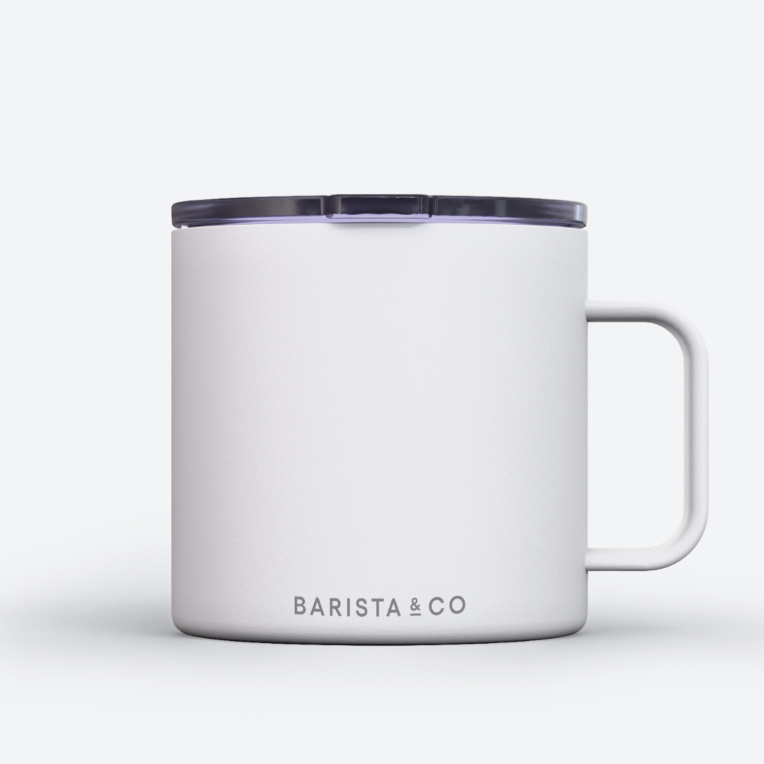 A white insulated mug with a dark translucent lid and a white handle, featuring the BARISTA & CO logo printed in gray near the bottom, set against a clean white background.