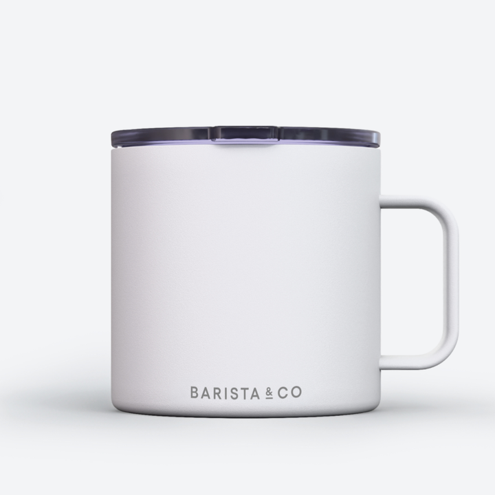 A white insulated mug with a dark translucent lid and a white handle, featuring the BARISTA & CO logo printed in gray near the bottom, set against a clean white background.