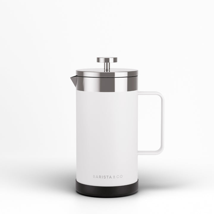 A white French press coffee maker with a brushed silver metal lid and plunger, featuring a white handle and a black base, shown on a clean white background. The brand name 'BARISTA & CO' is printed near the bottom.