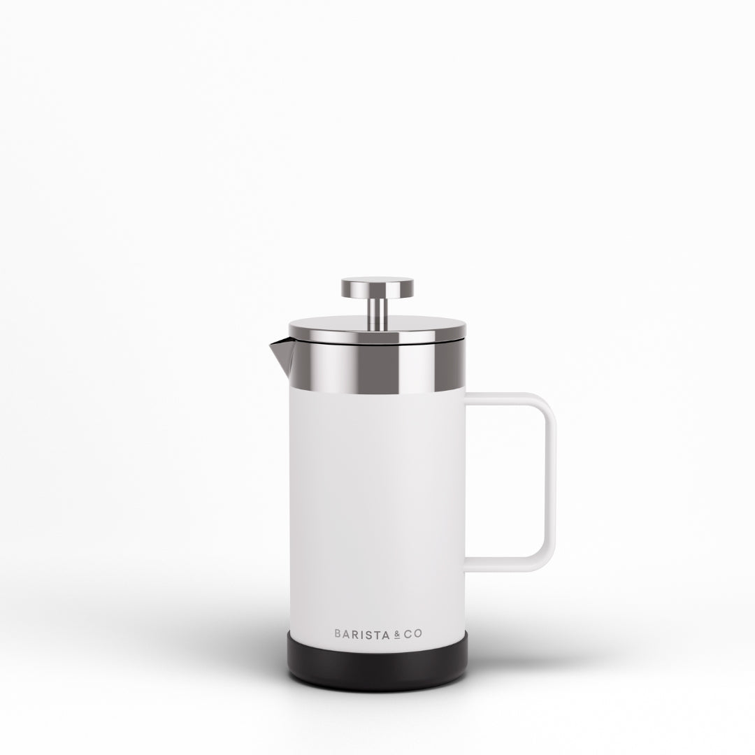 A modern white French press coffee maker with a stainless steel lid and plunger, featuring a black base and the BARISTA & CO logo, set against a clean white background.