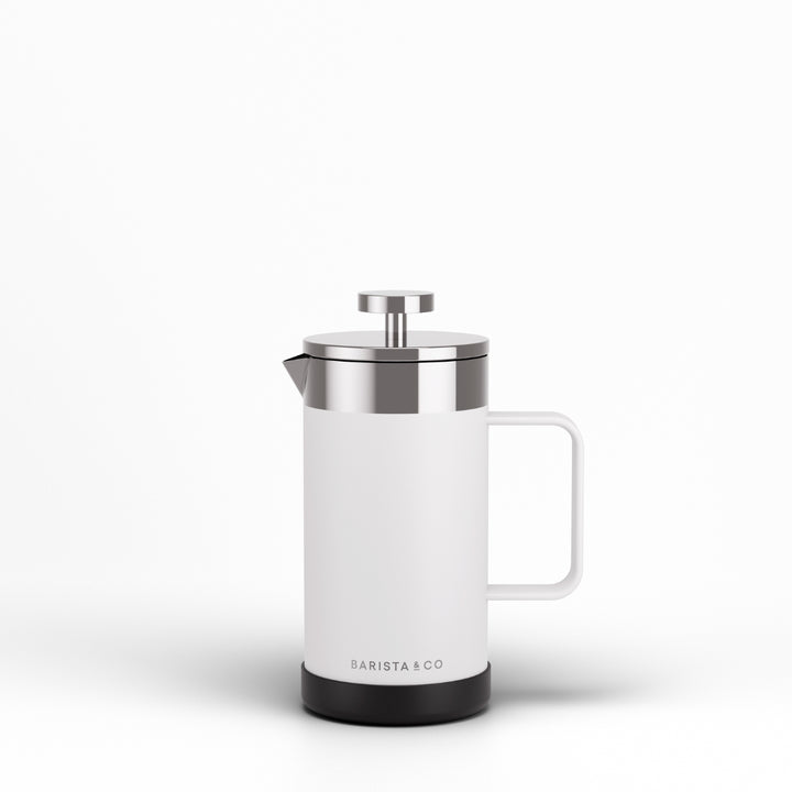 A modern white French press coffee maker with a stainless steel lid and plunger, featuring a black base and the BARISTA & CO logo, set against a clean white background.