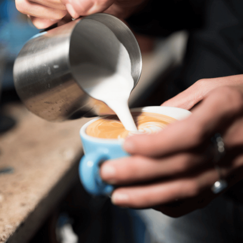 pouring milk from latte art jug