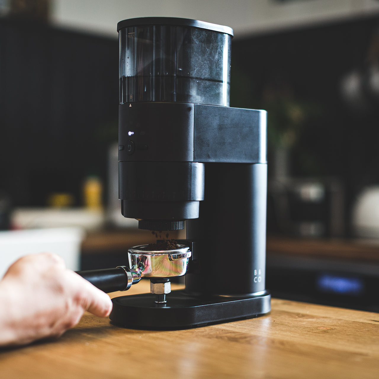 Electric coffee grinder in use